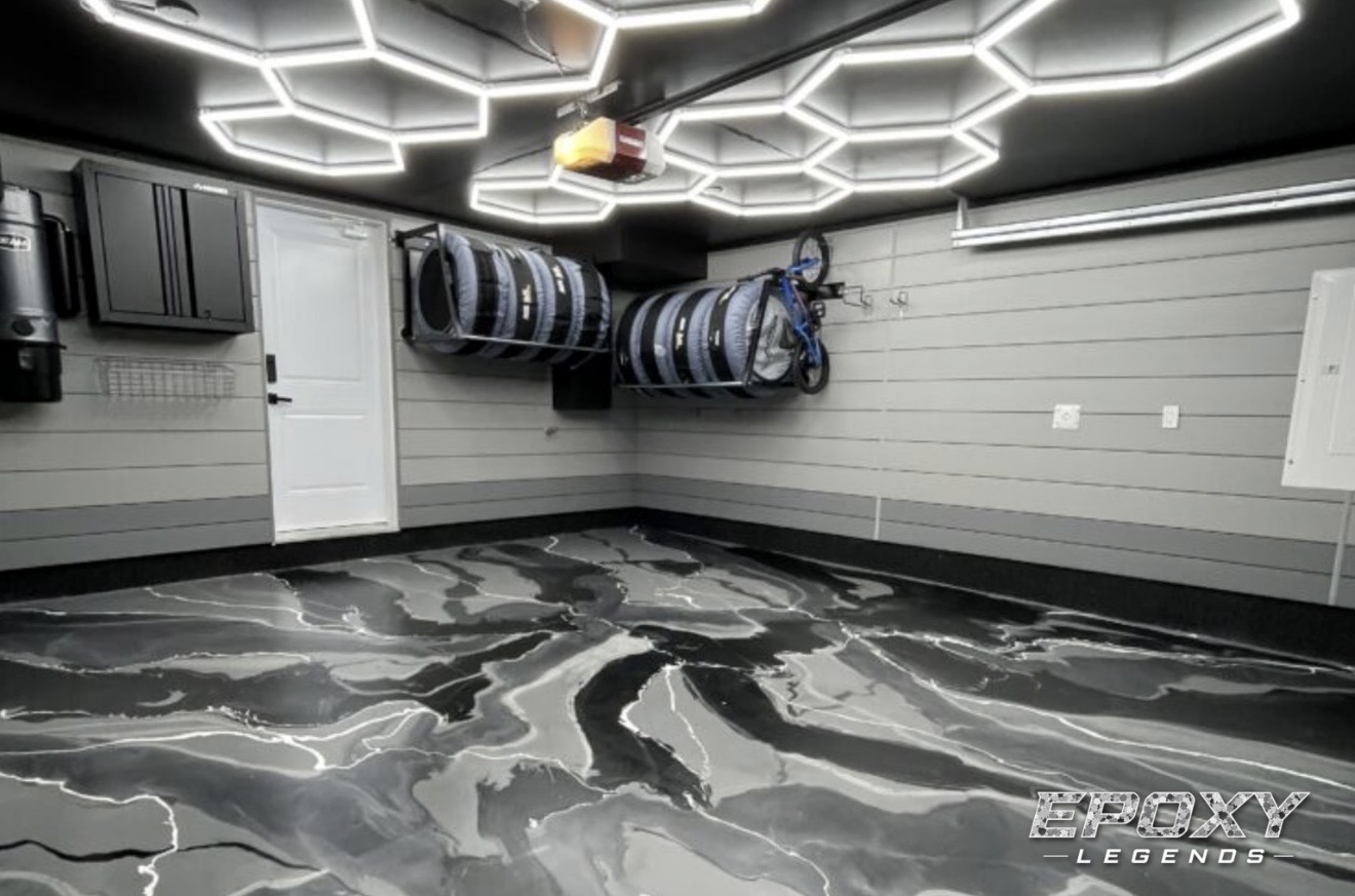 Black and white metallic epoxy garage floor with hexagon lighting installed by Epoxy Legends