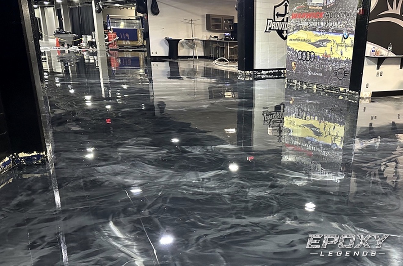 Charcoal metallic epoxy floor in an automotive dealership showroom installed by Epoxy Legends